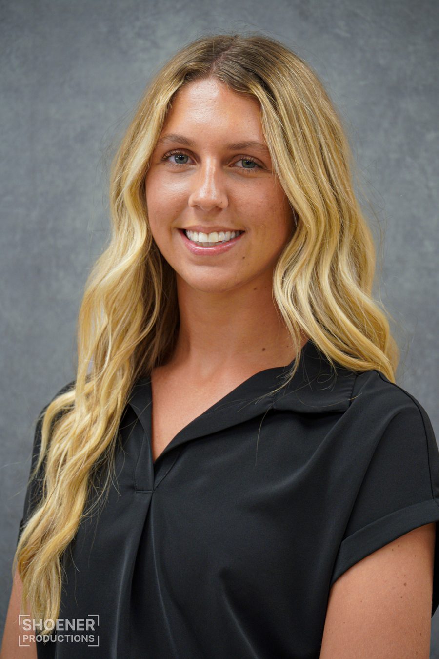 Professional headshot, woman in black blouse